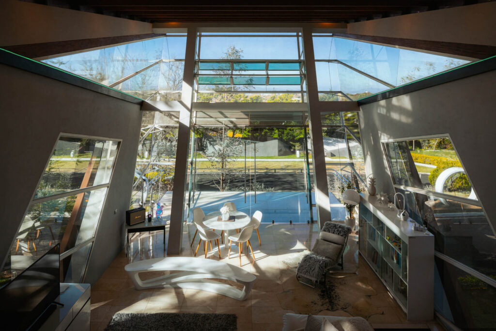 Daytime reflections across the faceted glass facade of Alianz Loft
