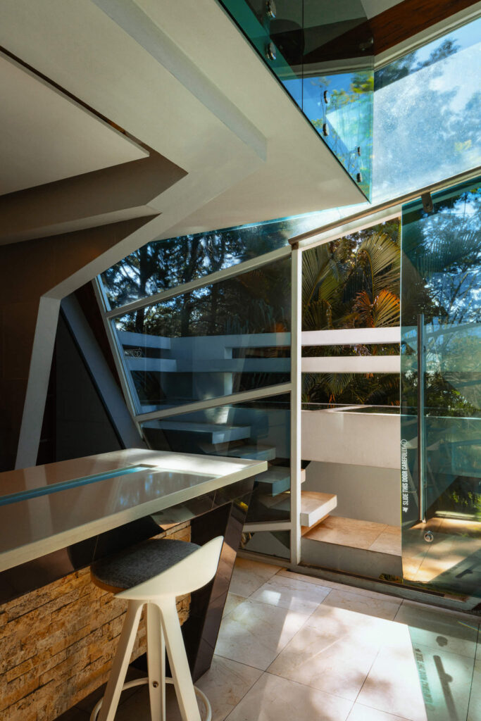 Interior level with sculptural stair and jacuzzi behind glass