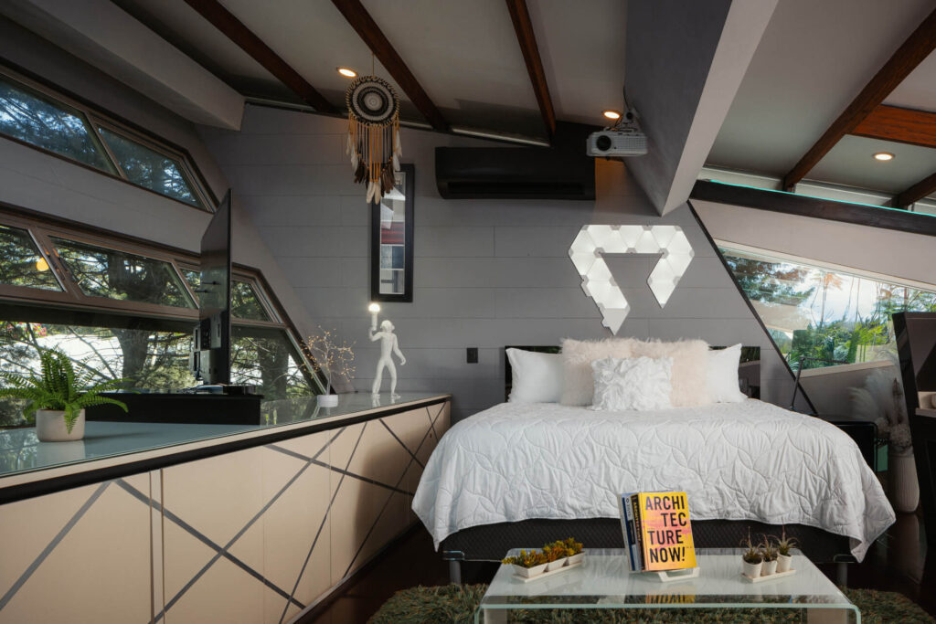 Warm bedroom with timber ceiling and garden view