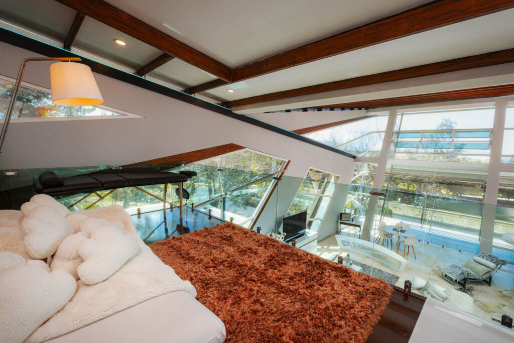 Decked terrace and jacuzzi surrounded by gardens