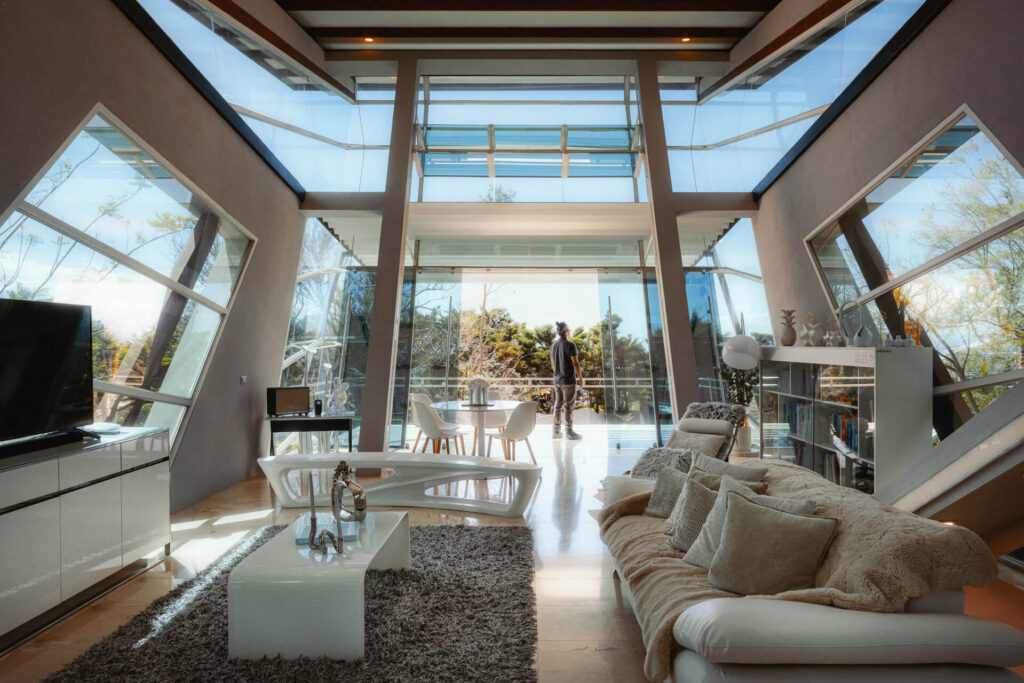 Wide living room with sofas and panoramic glass walls