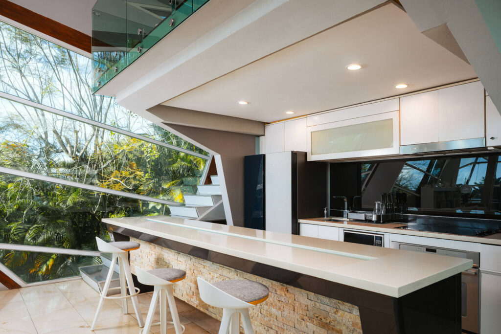 Corner sofa with an expansive garden view through glass