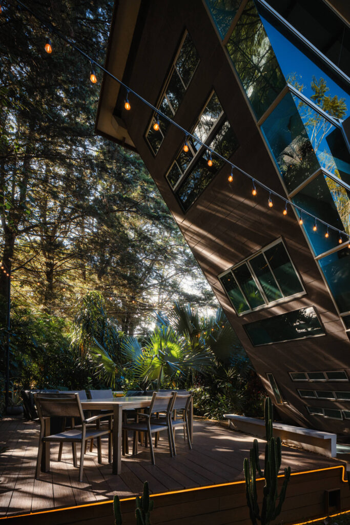 Interior with wood ceiling opening to the landscape through glass