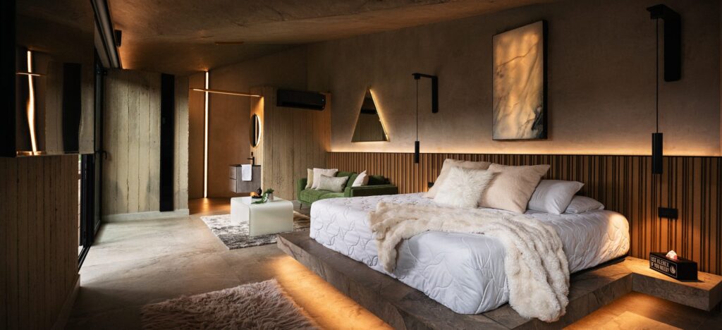 Light-filled bedroom of a Nebulae Module with a triangular window framing the sky