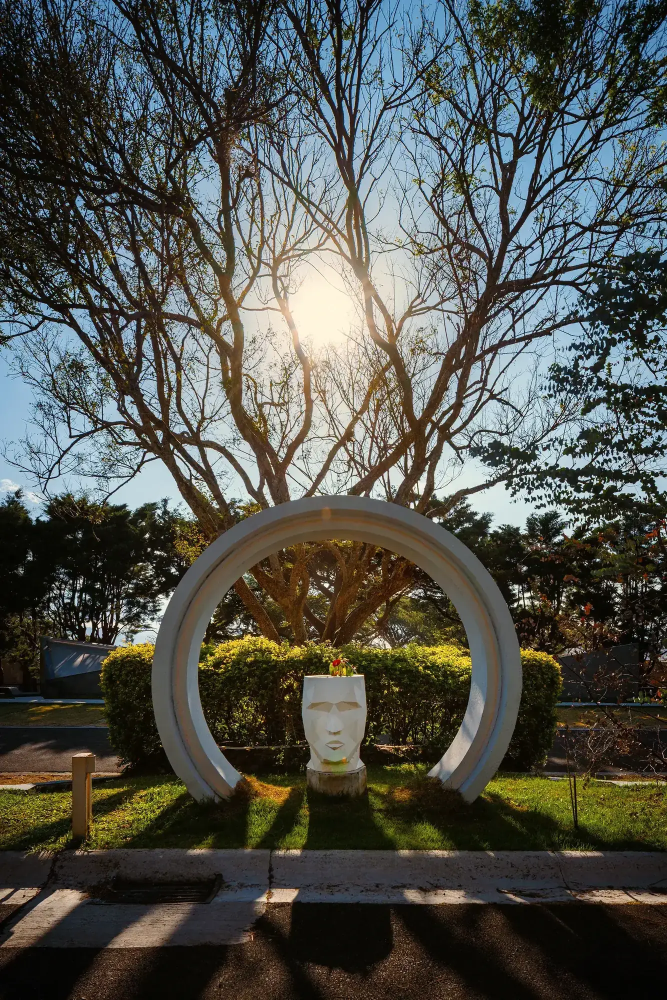 The iconic Cube sculpture of Nebulae framed by trees in the garden