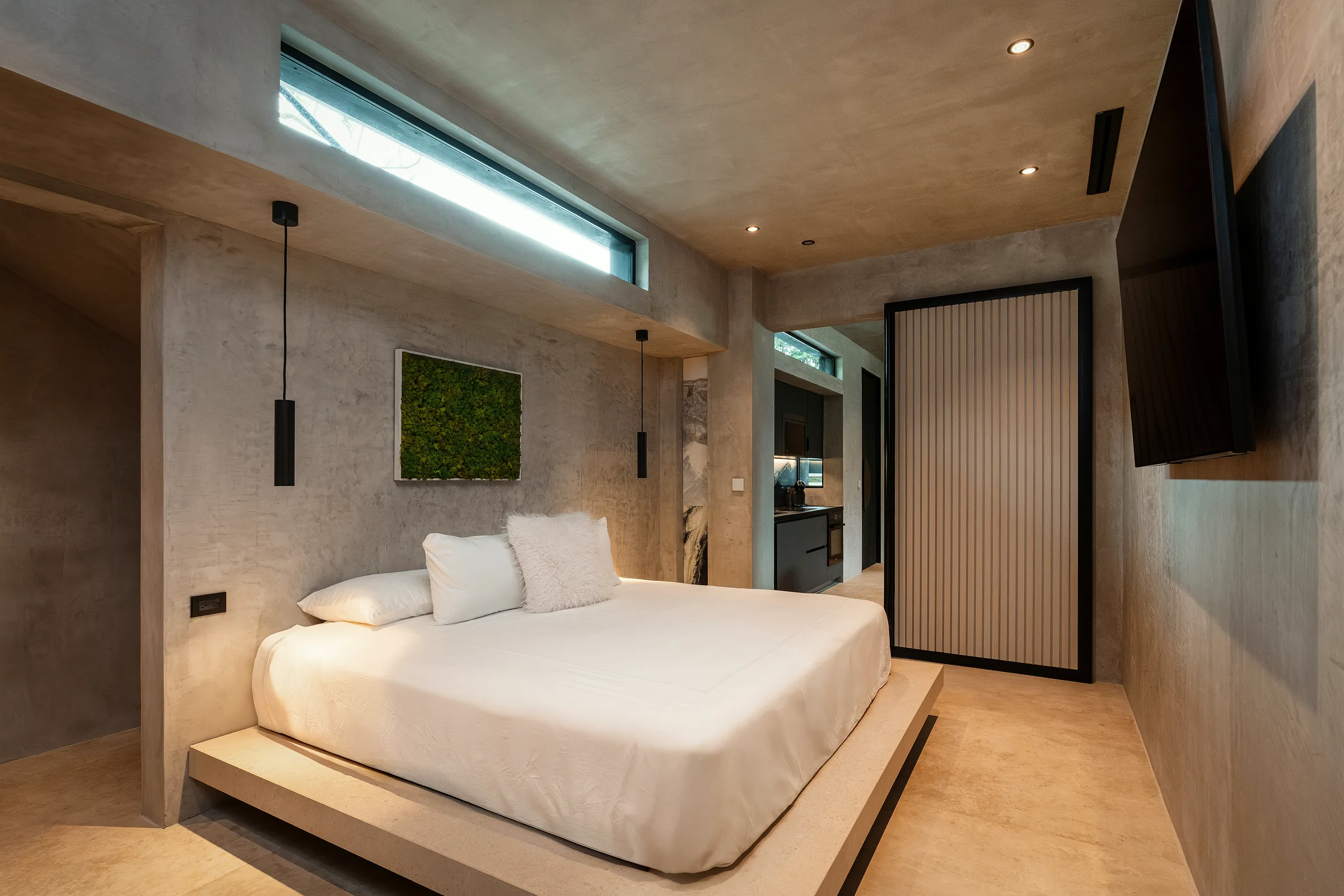 Water Cube bedroom in soft daylight with marble surfaces and a window to the pool