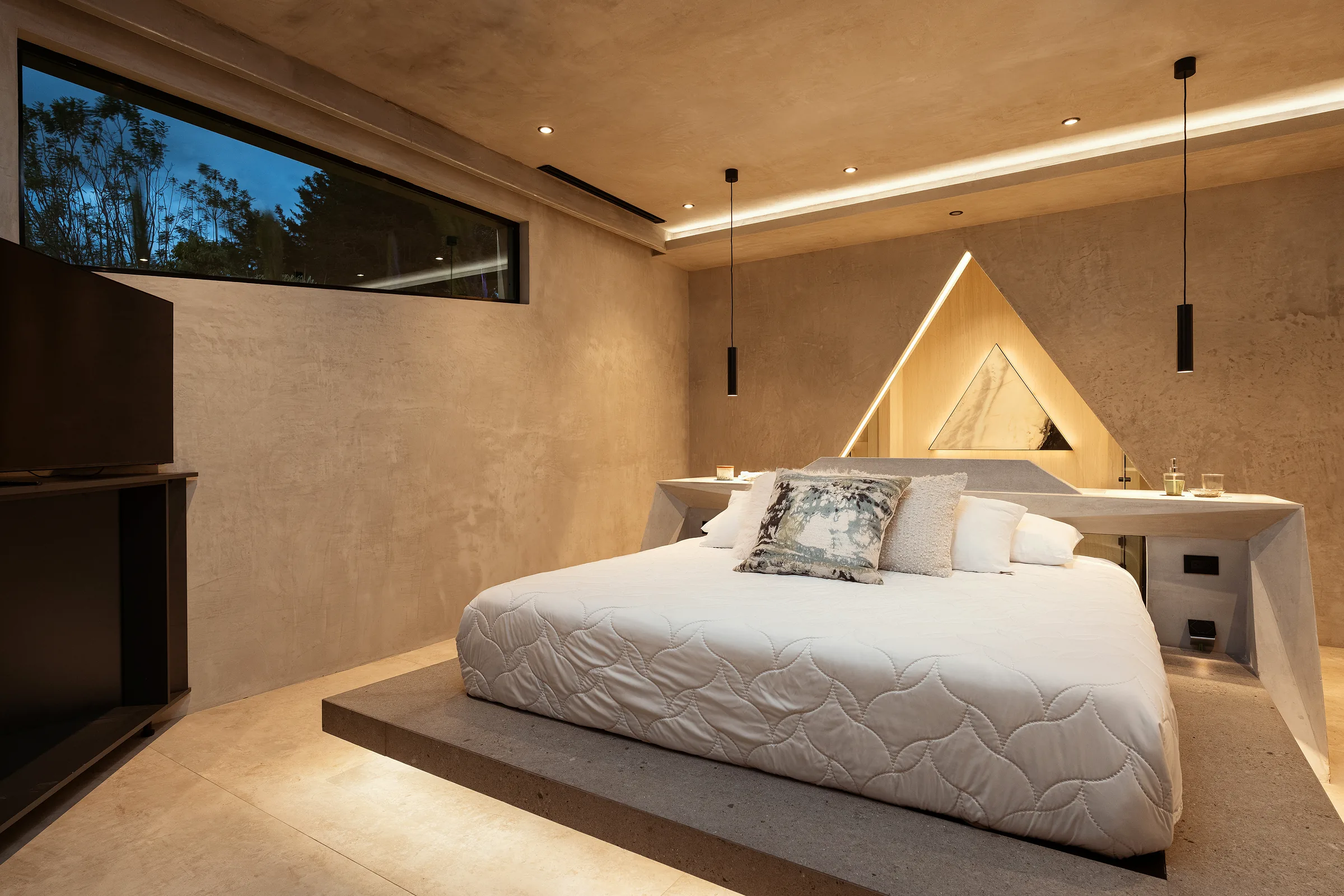 Illuminated triangular headboard motif in a Water Cube bedroom