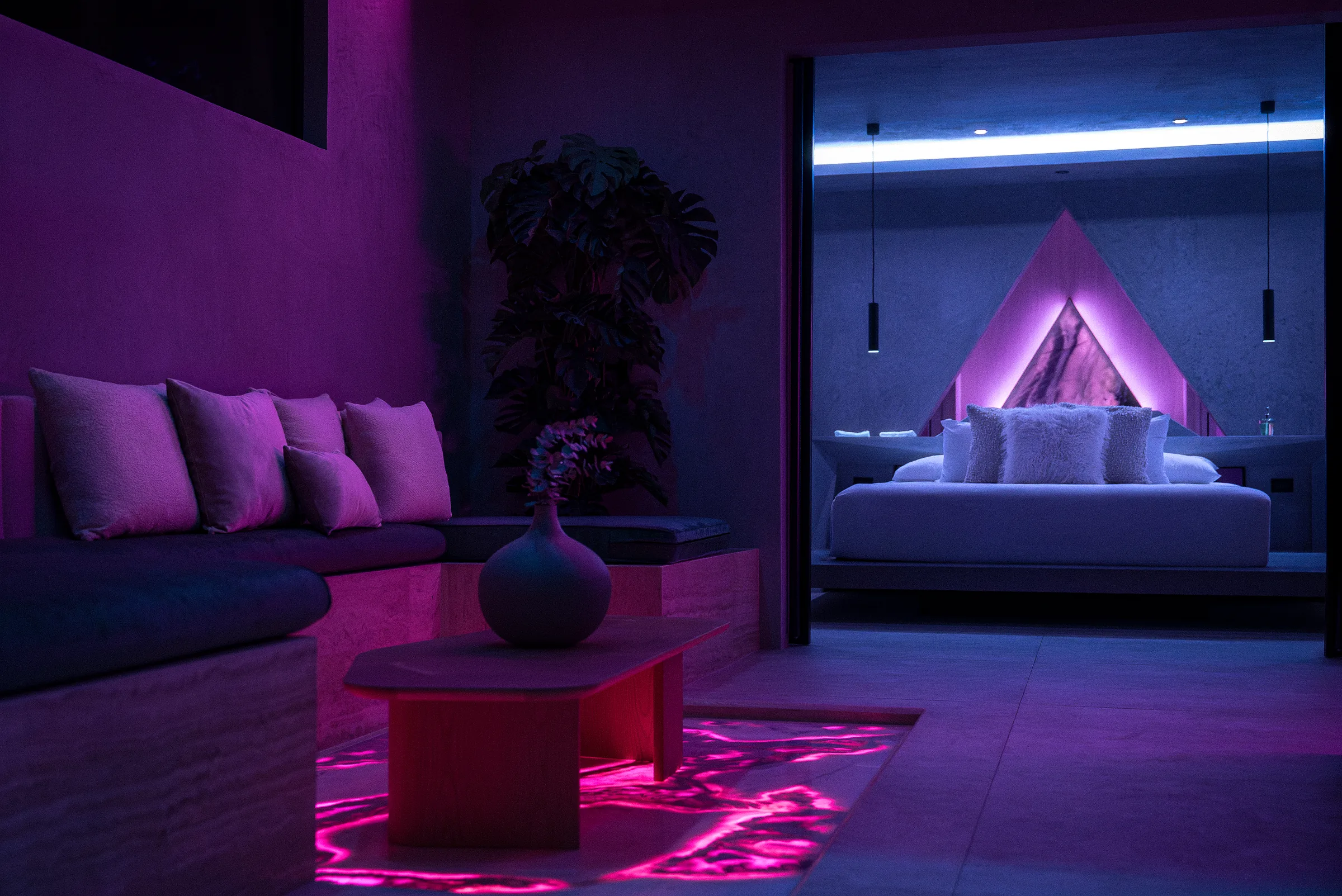 Lounge area with pink lighting, plants and marble in the Water Cube Suite