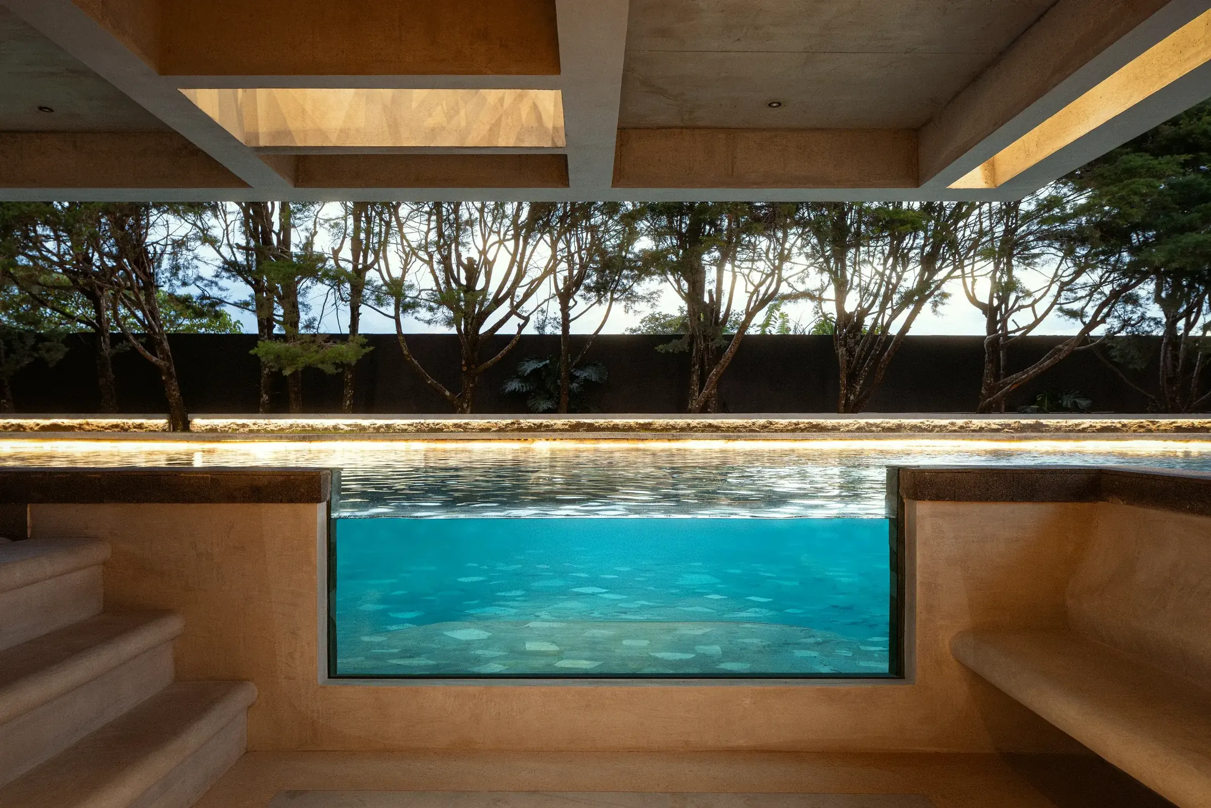 Underwater view through the pool window into the turquoise water at Nebulae