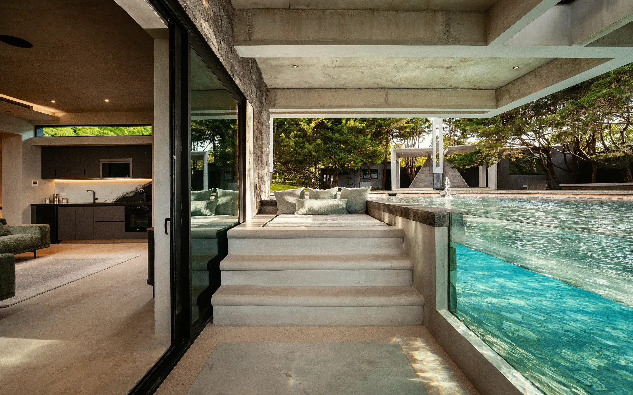Submerged outdoor lounge at the edge of the Nebulae pool, suspended between architecture and water
