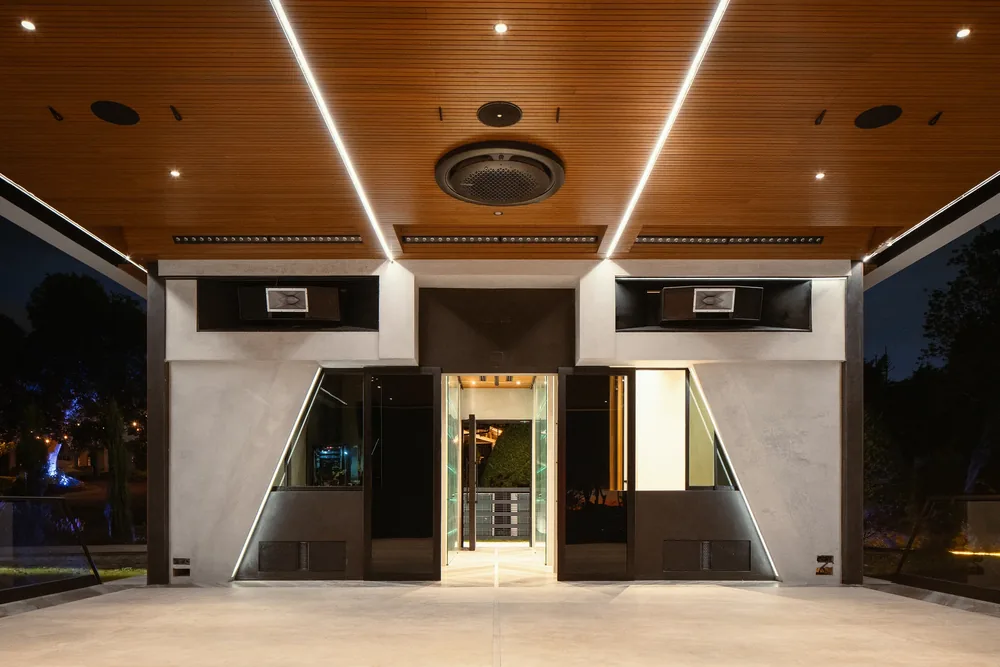 Illuminated entrance of the Nebulae center at night, with warm linear lighting over the doorway