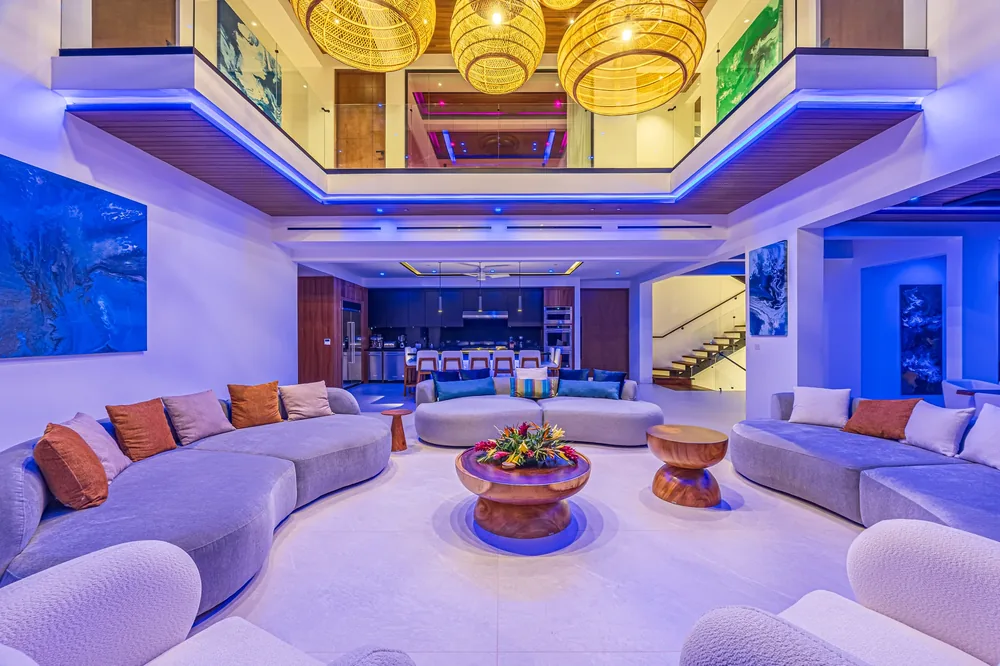 Living room with golden pendant lights and a warm evening scene in an Alianz project