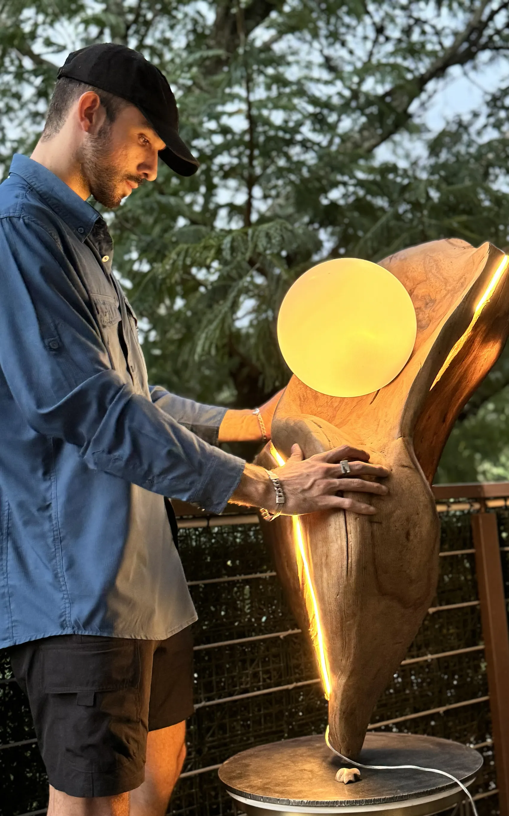 David Morera standing with Brisa in daylight, his hand resting on the wood