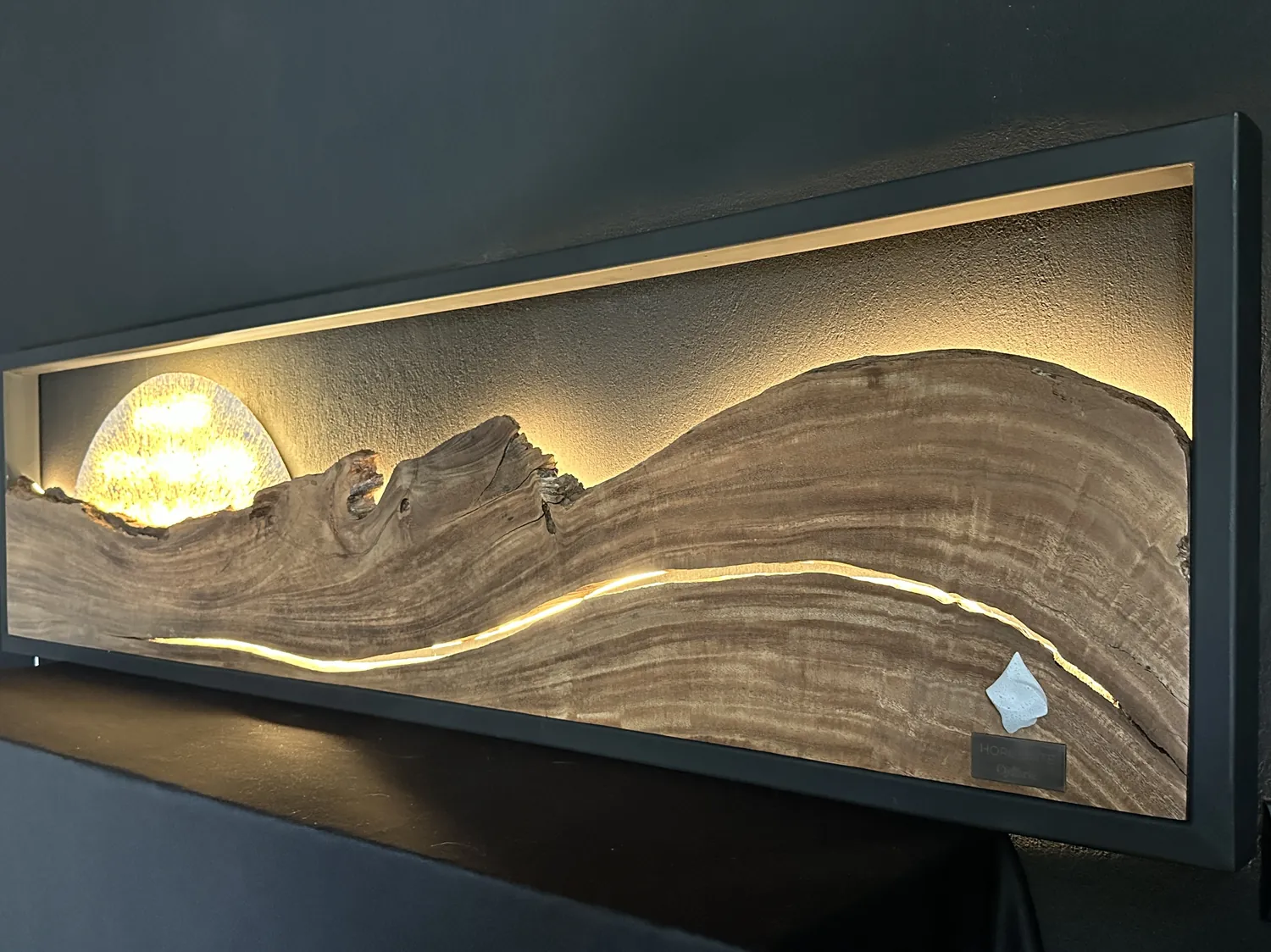 Horizonte in full width — backlit sun and illuminated crack across the wooden landscape