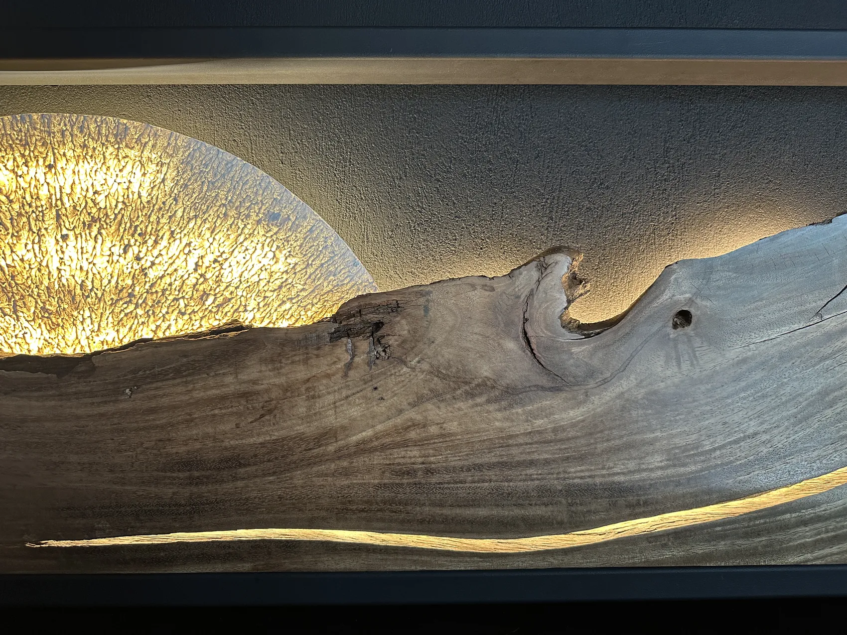 Detail of Horizonte — the glowing textured sun rising behind the crest of the wood