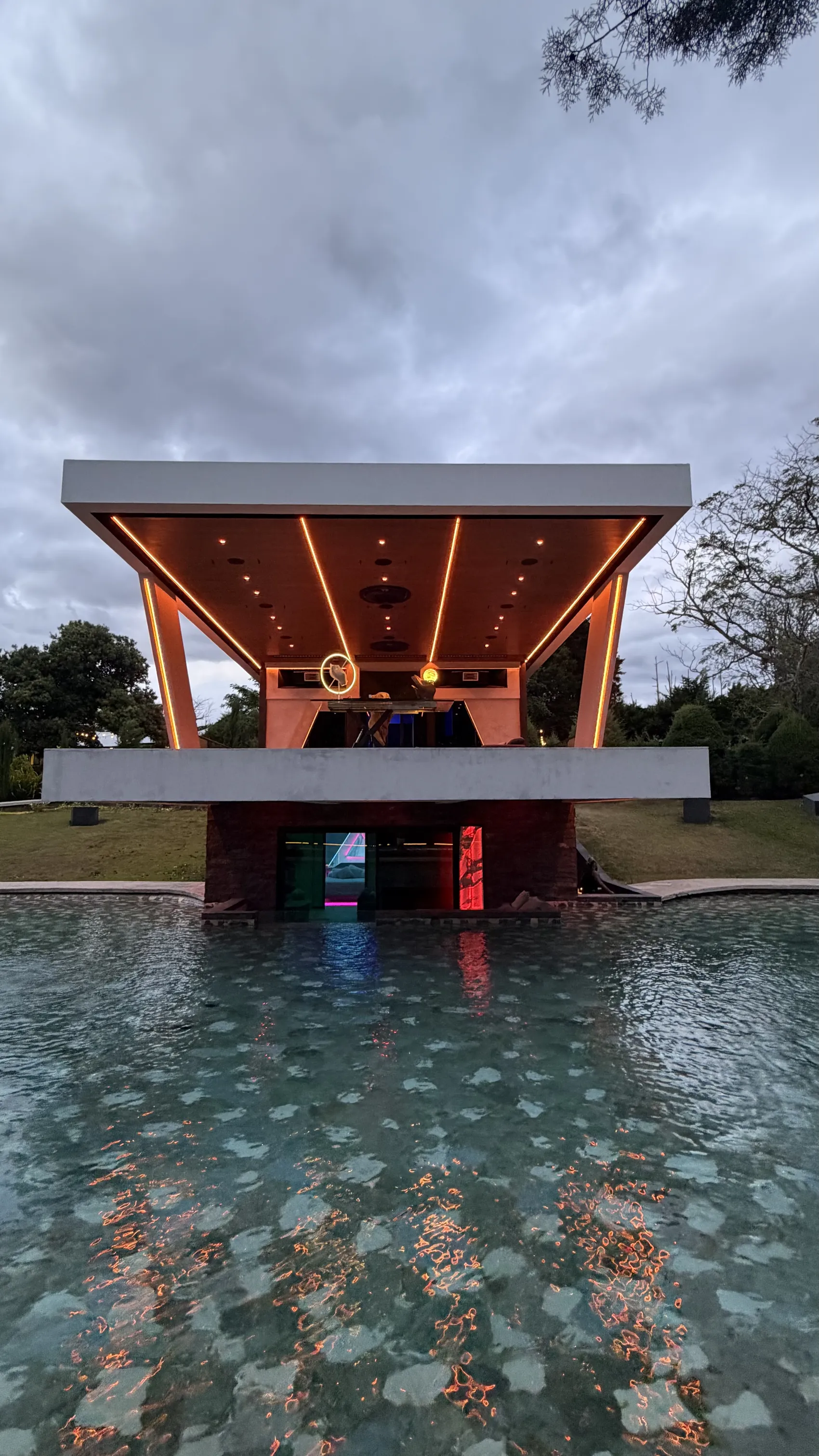 Nebulae pavilion by day over its reflecting pool