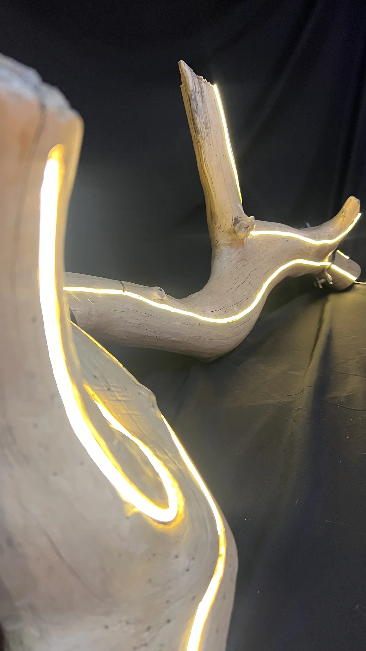 Detail of Trueno — the embedded ribbon of light curling through the sanded wood